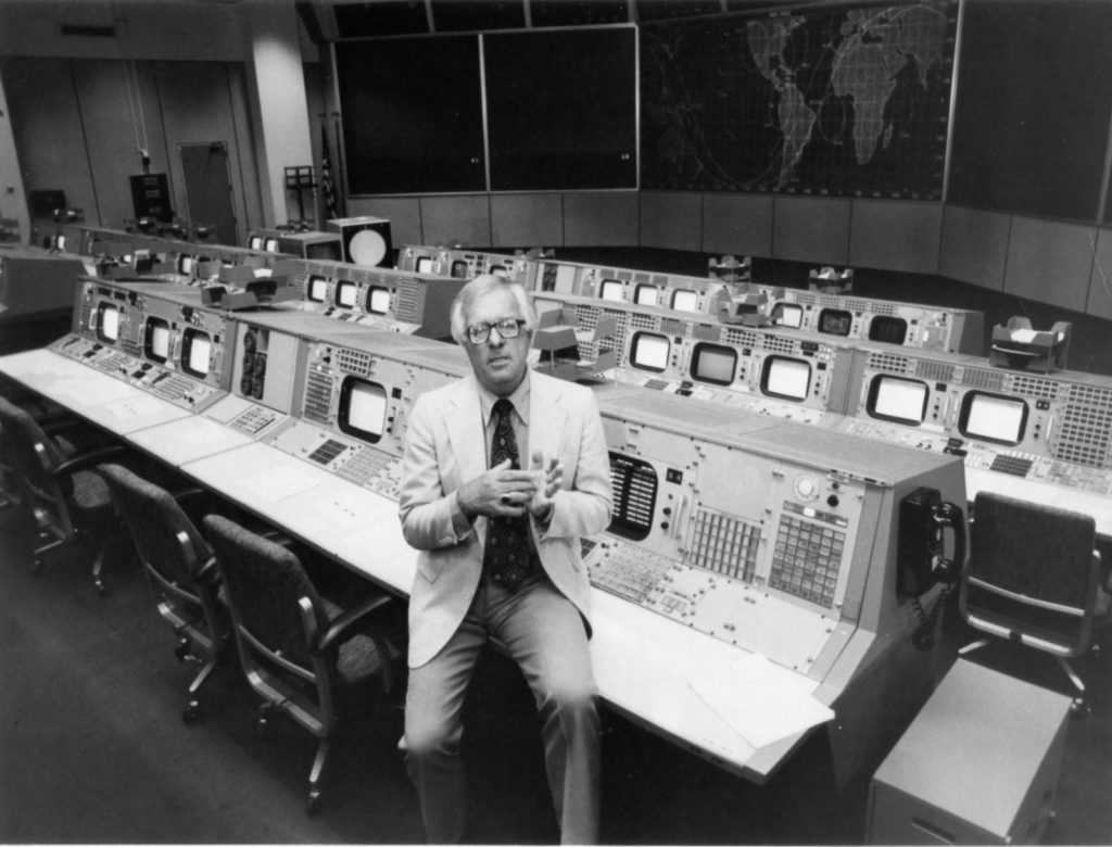Ray Bradbury leaning against a row of computers at a NASA facility in Houston, Texas