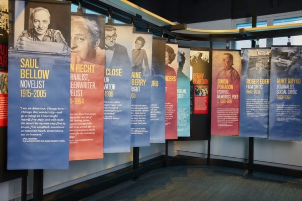Hanging banners in red and blue showing different writers in the Chicago gallery at the American Writers Museum in Chicago, IL