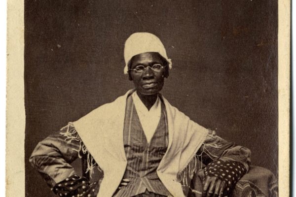 Sojourner Truth seated, pictured from the waist up with arms on arm rests