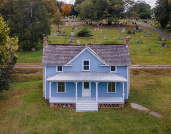 Pauli Murray's childhood home, a blue house in front of a graveyard now known as the Pauli Murray Center for History and Social Justice