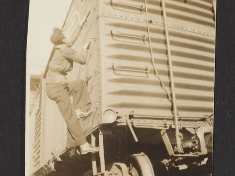 A photo of a young Pauli Murray climbing the side of a freight train