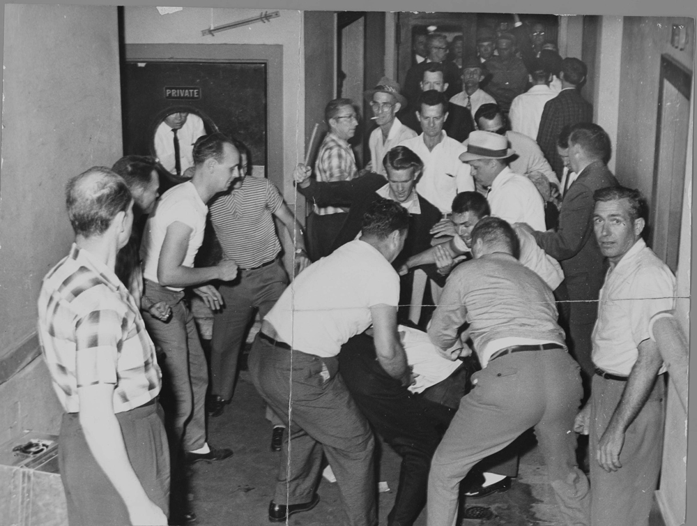 A mob of white people beat Freedom Riders in Birmingham.