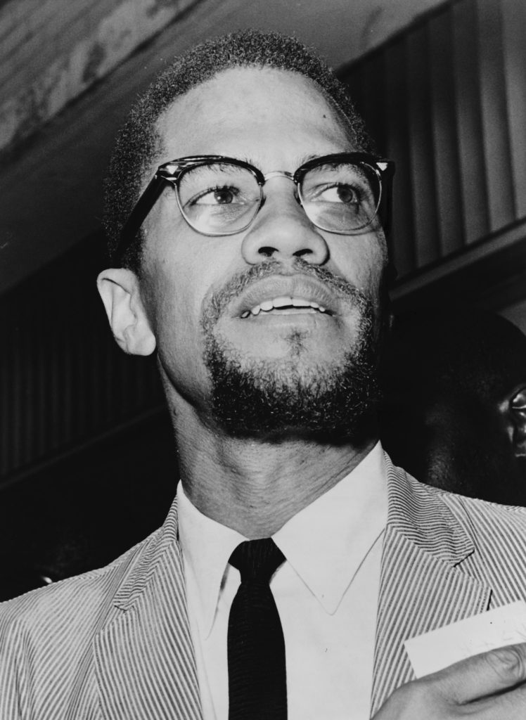 Malcom X looking slightly left of the camera at Queens Court