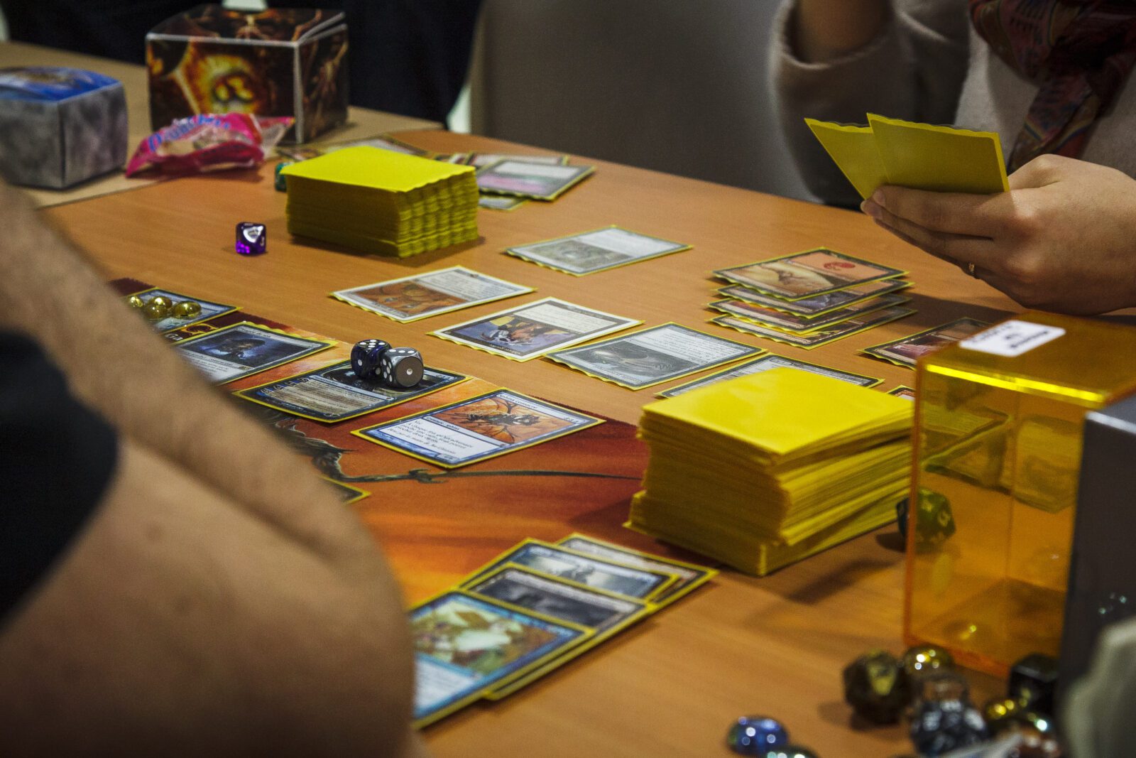 A close up of a Magic: the Gathering game on a wood table. Tourtefouille, CC BY-SA 4.0 https://creativecommons.org/licenses/by-sa/4.0, via Wikimedia Commons