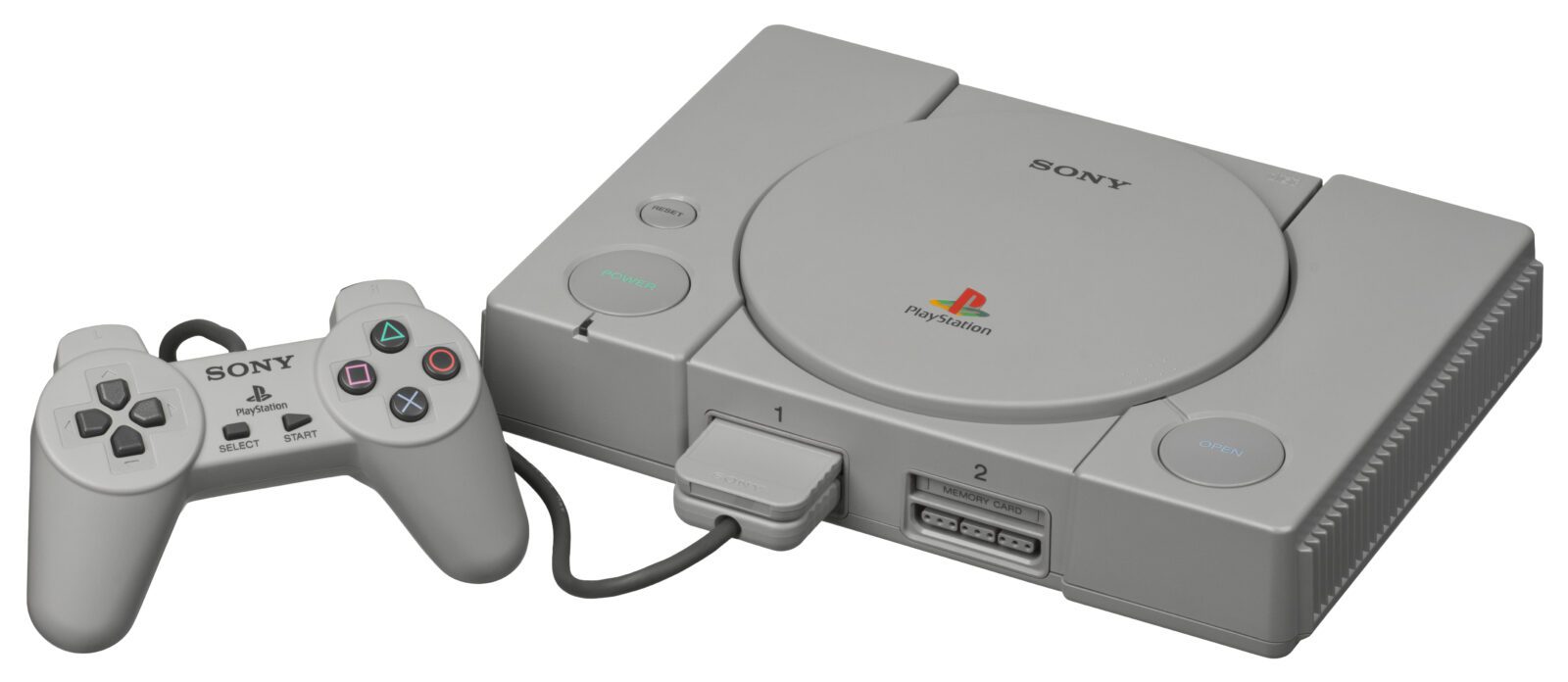 A grey Playstation console with one controller plugged into it.